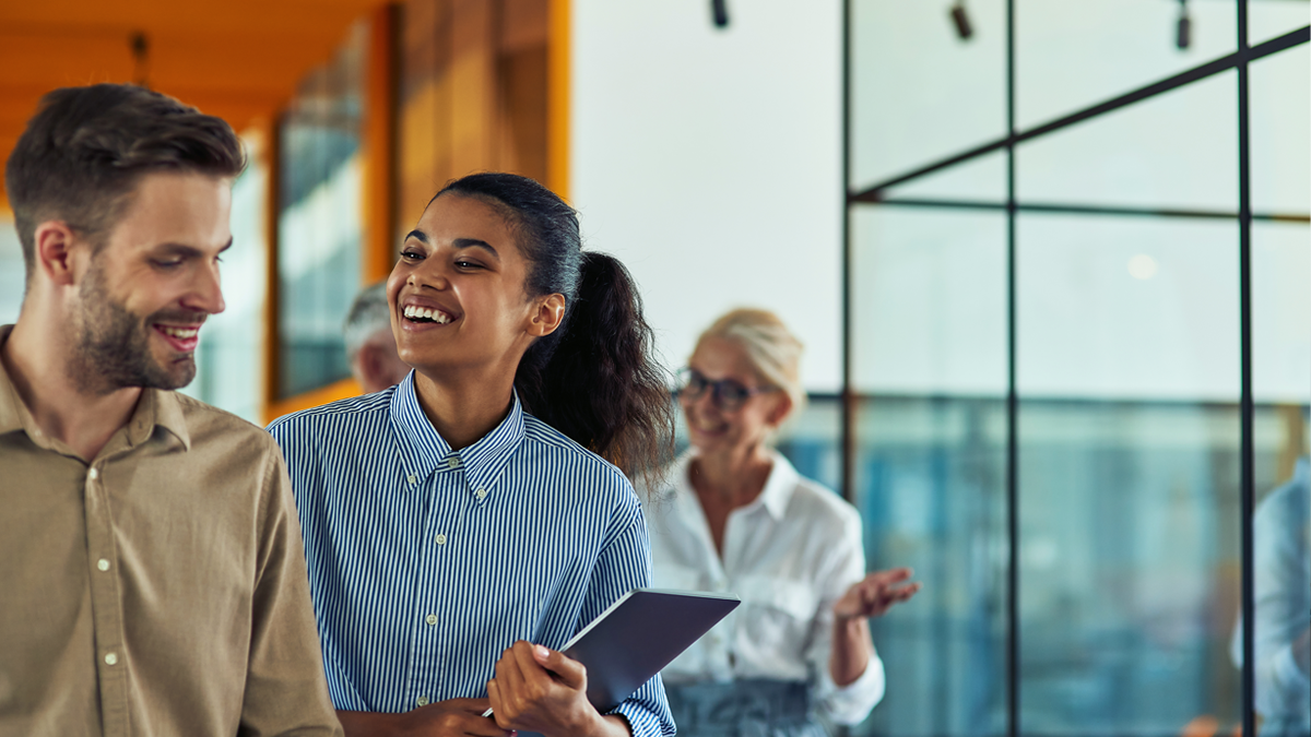 Ashley Furniture employees smiling enjoying the benefits they receive from their careers.