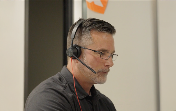 Ashley associate with a headset at an office