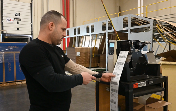 Ashley Employee Scanning a Label in a warehouse.