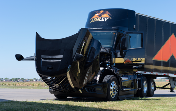 Ashley truck with an open hood, parked in the grass