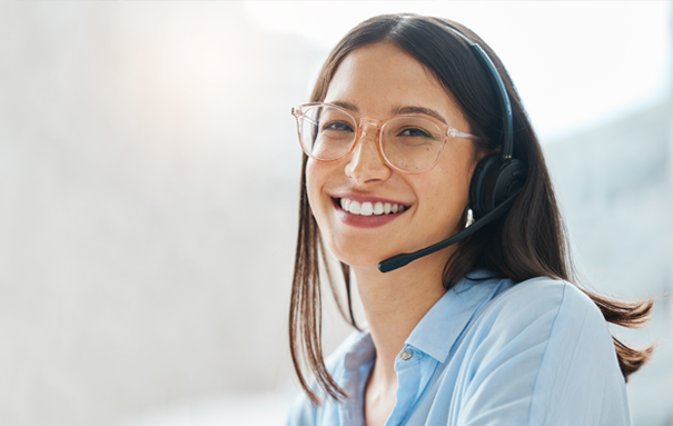 Female Ashley employee smiling with a headset