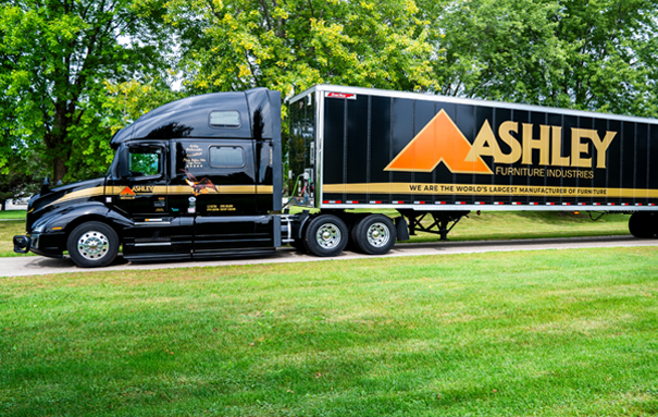 Ashley Truck parked in a grassy area with trees in the background