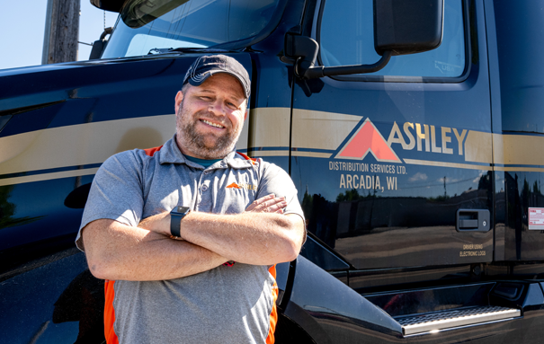 Ashley Driver in front of an Ashley Truck cabin