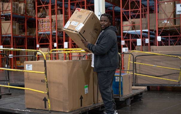 Ashley male associate lifting a box