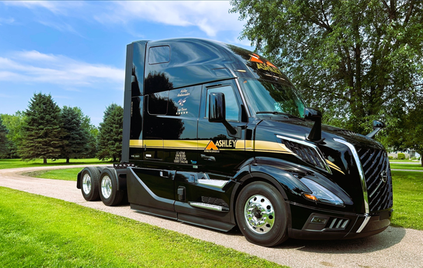 Ashley Truck cab parked in a dirt road with some trees