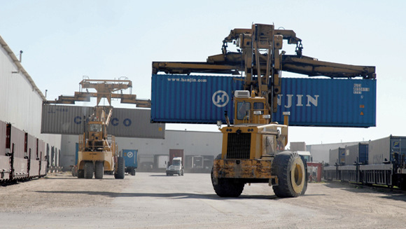 Containers being lifted by heavy machines