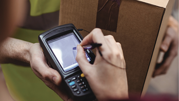 Ashley distribution center employee with a warehouse device