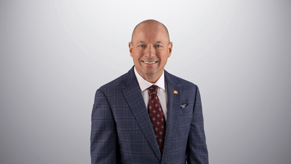 Todd Wanek is smiling looking at the camera