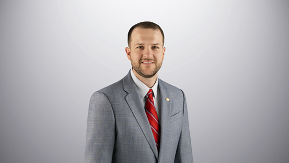 Travis Wagner is smiling looking at the camera